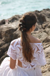 Midsection of woman sitting on beach