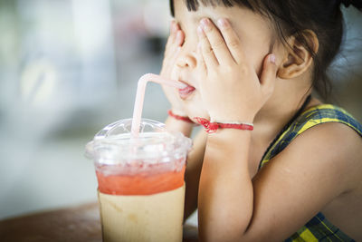 Close-up of woman drinking glass