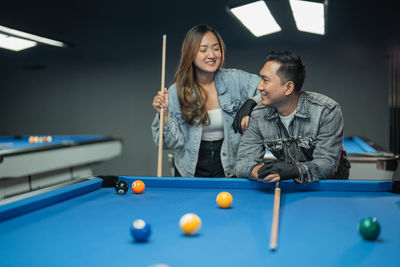 Friends playing pool