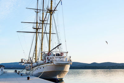 Boats in sea against clear sky