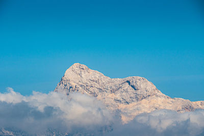 Low angle view of mountain against blue sky