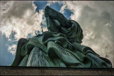 Low angle view of statue against cloudy sky