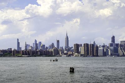 Panoramic view of sea and buildings against sky