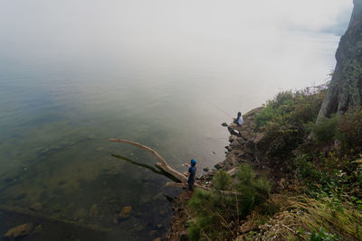 High angle view of people by sea against sky