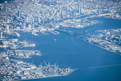 High angle view of sea and buildings in city