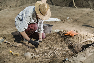 Rear view of child working on sand