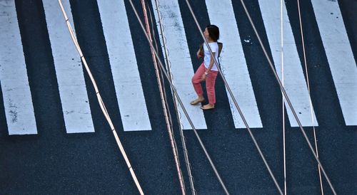 High angle view of woman walking on road