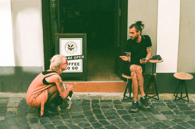 Full length of couple sitting on chair