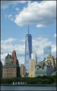 Cityscape against cloudy sky