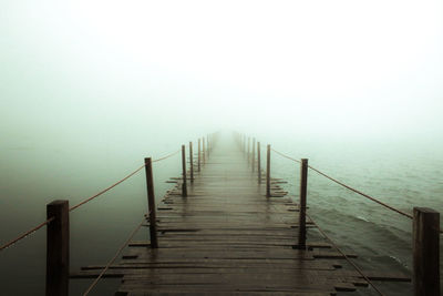Pier over sea against sky