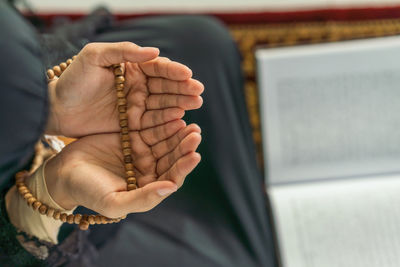 Midsection of woman praying