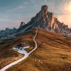 High angle view of farmhouse on mountain range against sky