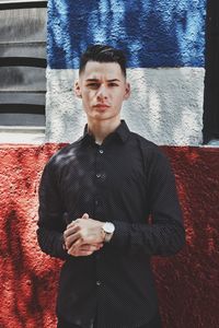 Portrait of young man standing outdoors