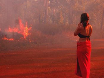 Full length of woman standing at sunset