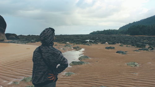 Rear view of man standing on beach