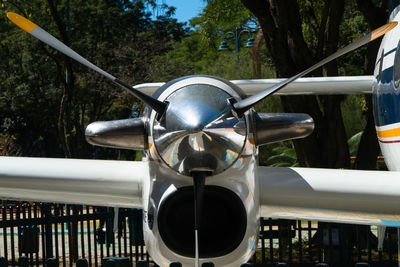 Close-up of airplane against trees