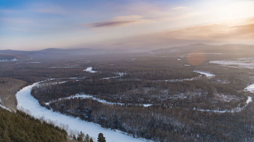 Aerial view of landscape against sky during winter