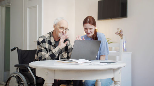 Nurse and patient talking on video call at clinic