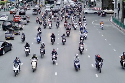 High angle view of motor scooters moving on road