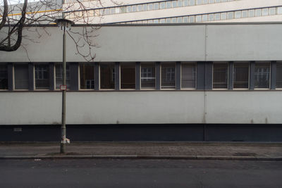 Empty road by building in city