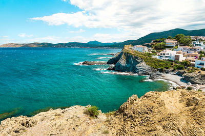 Scenic view of sea and buildings against sky