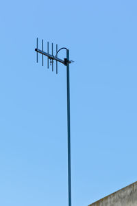Low angle view of television aerial against clear sky