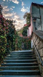 Low angle view of staircase by building against sky