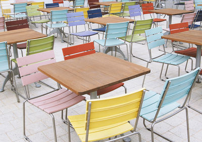 High angle view of empty chairs and table at restaurant