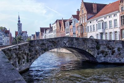 Arch bridge over river in city