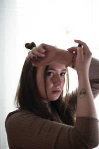 Portrait of young woman wearing hat