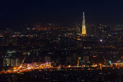 High angle view of city lit up at night