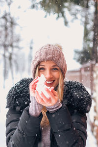 Portrait of smiling young woman in snow