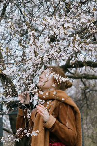 Low section of woman standing against trees