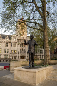 Statue against sky in city