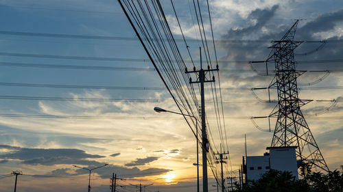 Low angle view of electricity pylon against sky