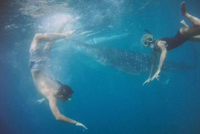 Man and woman swimming in sea