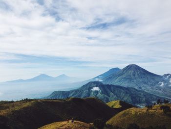 Scenic view of mountains against cloudy sky