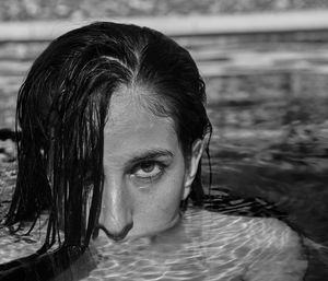 Close-up portrait of young woman in swimming pool