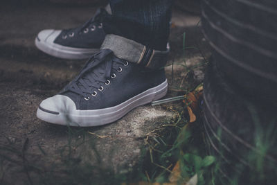 Low section of man wearing shoes standing on ground