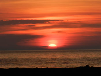 Scenic view of sea against orange sky