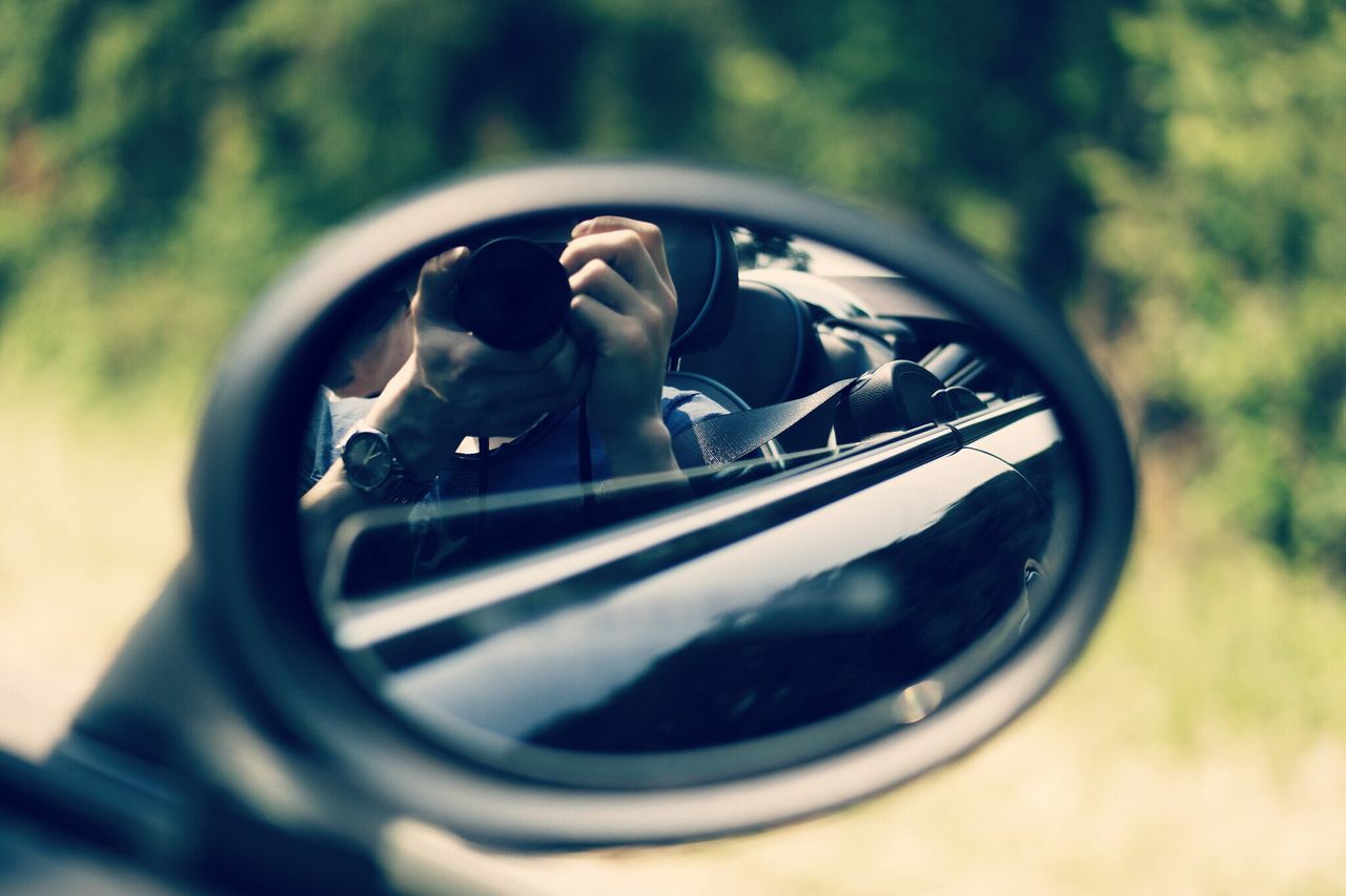 transportation, land vehicle, mode of transport, leisure activity, car, lifestyles, men, selective focus, focus on foreground, reflection, close-up, riding, bicycle, motorcycle, photography themes, camera - photographic equipment, part of, day