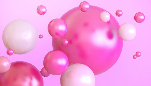 Close-up of balloons against colored background