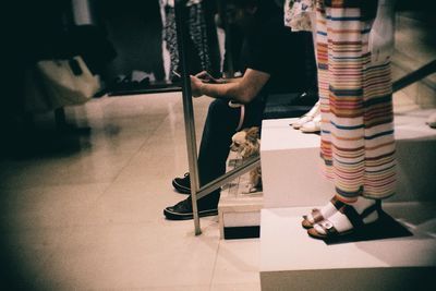 Low section of man standing on tiled floor