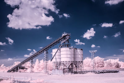 Infrared image of storage tanks against sky