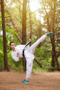 Rear view of woman playing in park