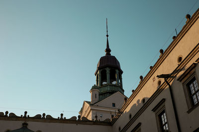Low angle view of buildings against clear blue sky