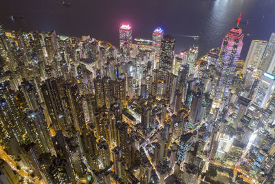 High angle view of illuminated modern buildings in city at night