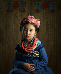 Portrait of cute girl sitting outdoors