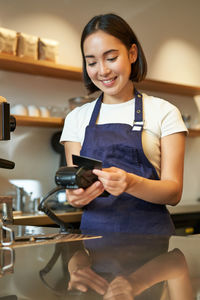 Portrait of young woman using mobile phone