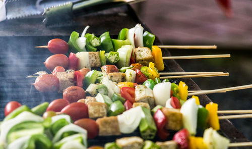 Close-up of multi colored candies on barbecue grill